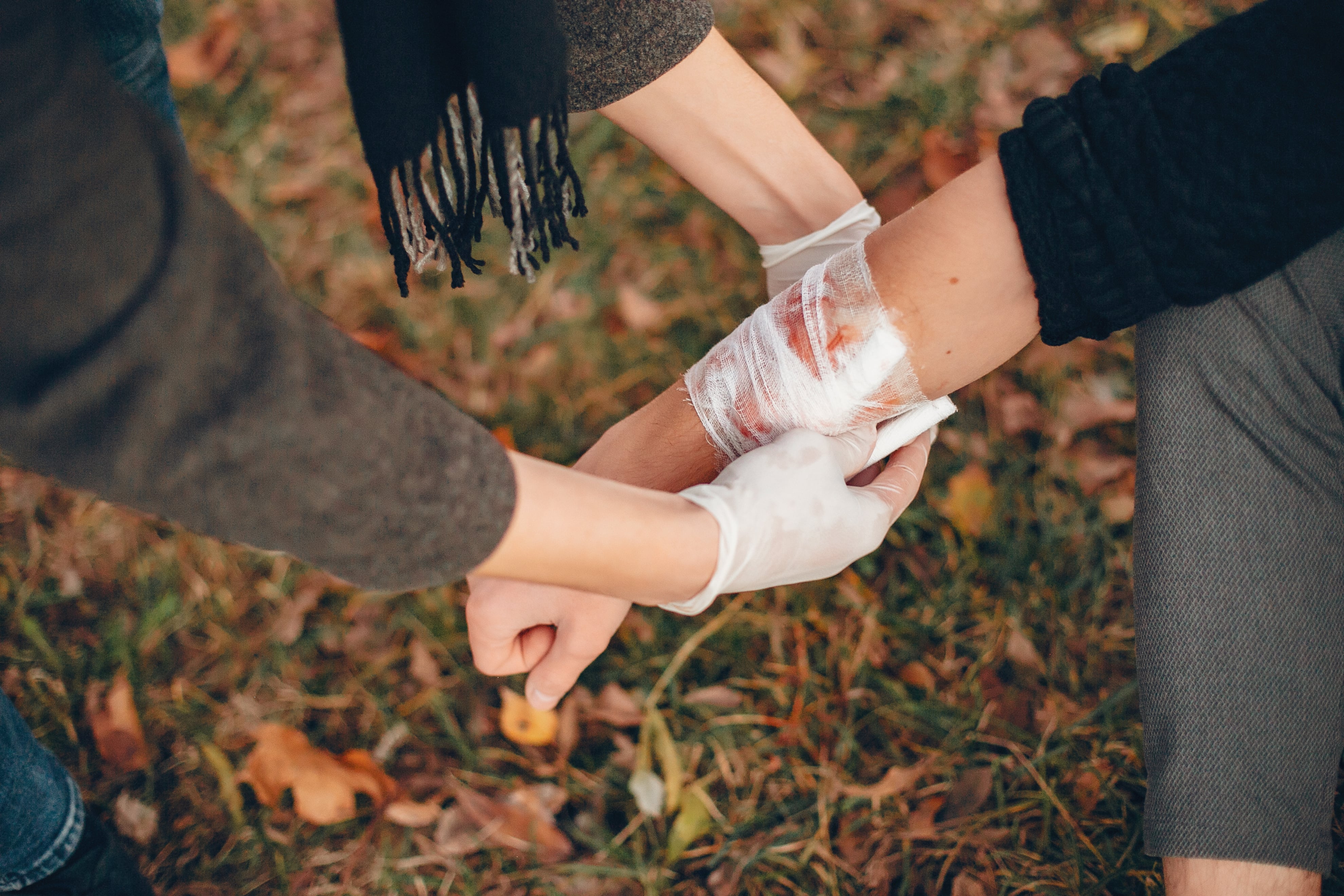 providing first aid park man bandaged injured arm guy helps friend 2 min